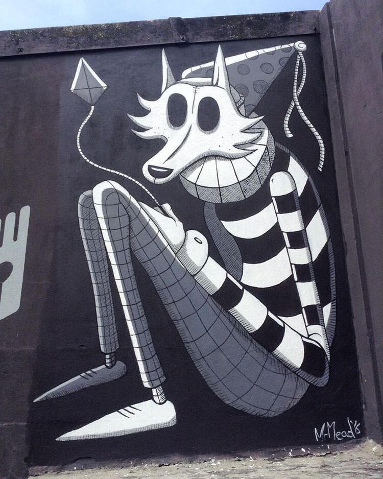 A whimsical mural depicts a cartoon wolf with exaggerated eyes wearing a striped sweater and hat, flying a kite. The tone is playful and surreal.